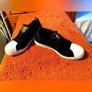 Adidas black quilted with white leather toe sneakers.